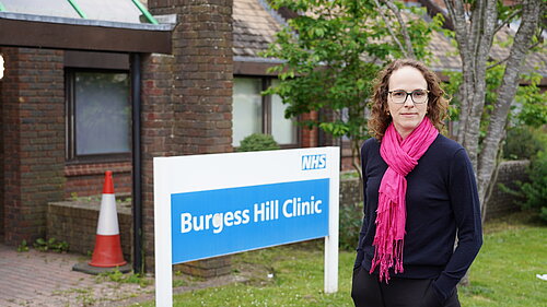 Alison Bennett next to NHS Building Sign