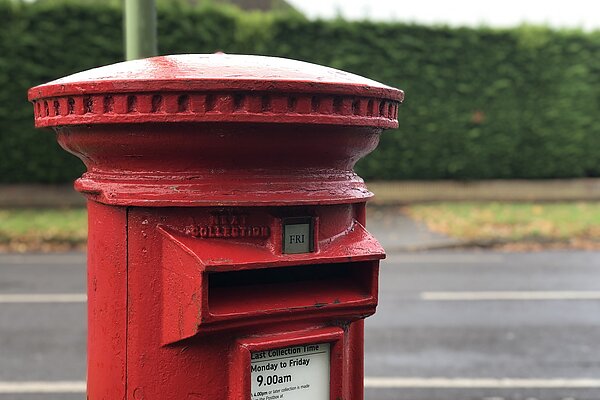 Red pillar post box