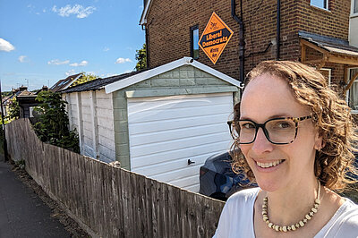 Alison Bennett outside a Mega Board sign